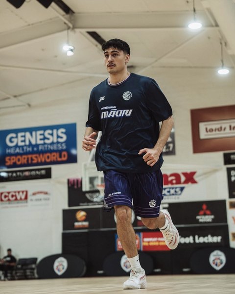 A player in a Poitūkohu Māori shirt runs on court in Cairns.