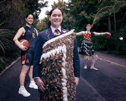 Three figures side by side: a basketball player in uniform holding a ball, a student in school uniform wearing a cloak, and a kapa haka performer holding poi.