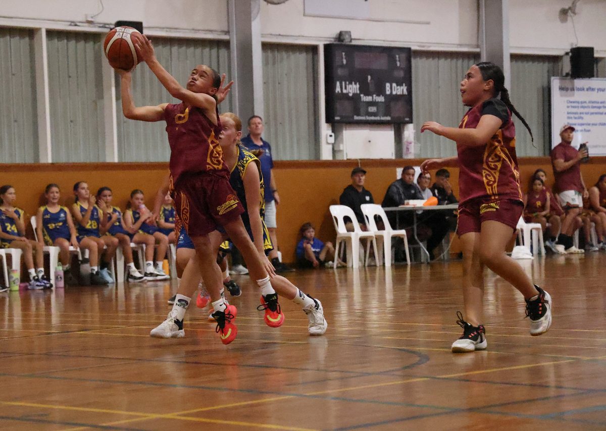 Rotorua player takes the ball towards the basket during a game.