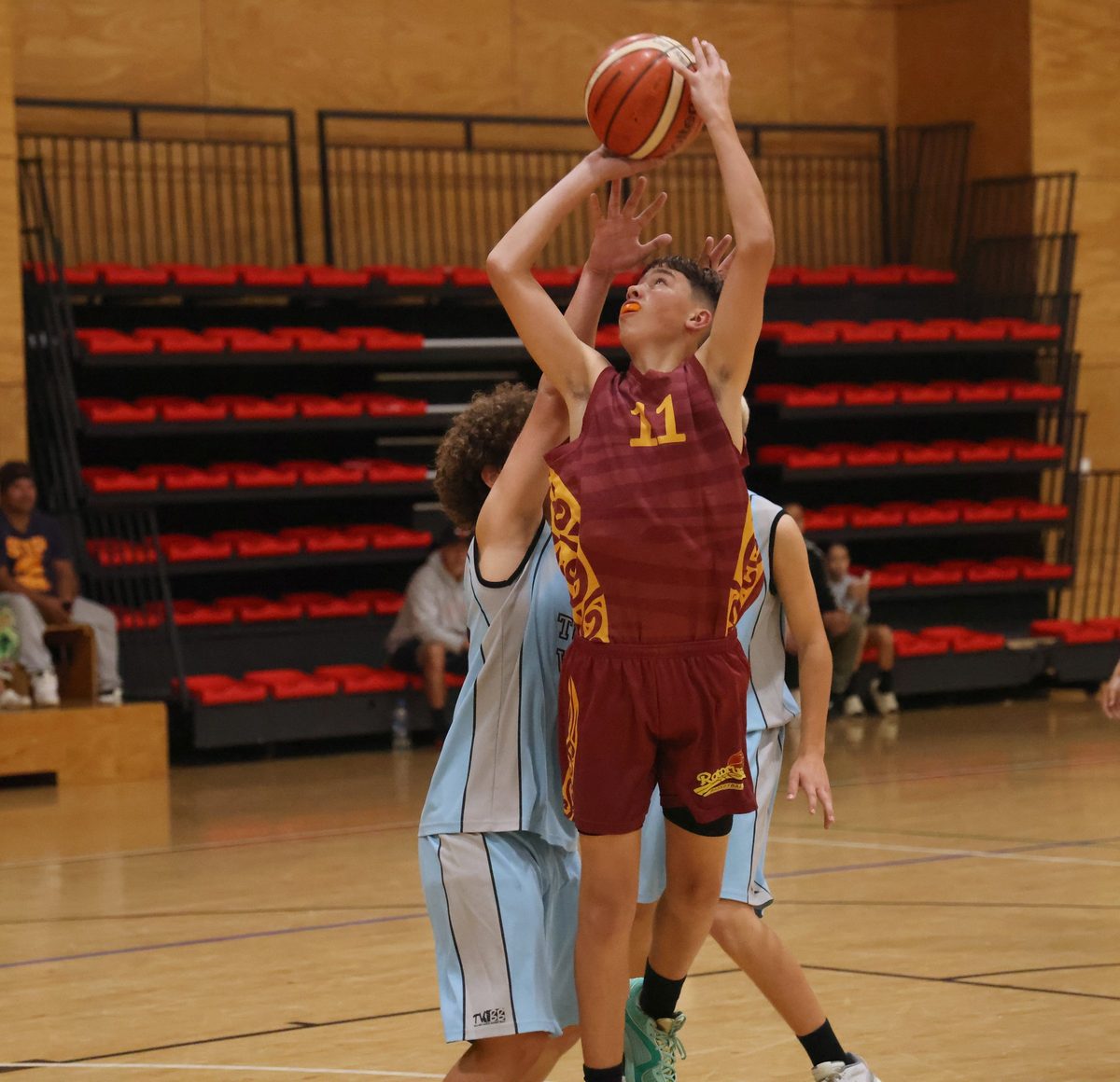 Rotorua number 11 prepares a shot with a defender close behind.