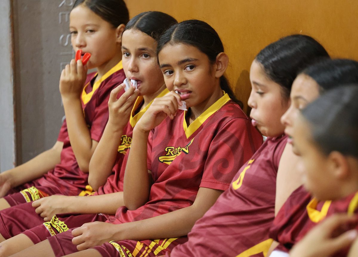 Rotorua junior players watch the game from the bench.