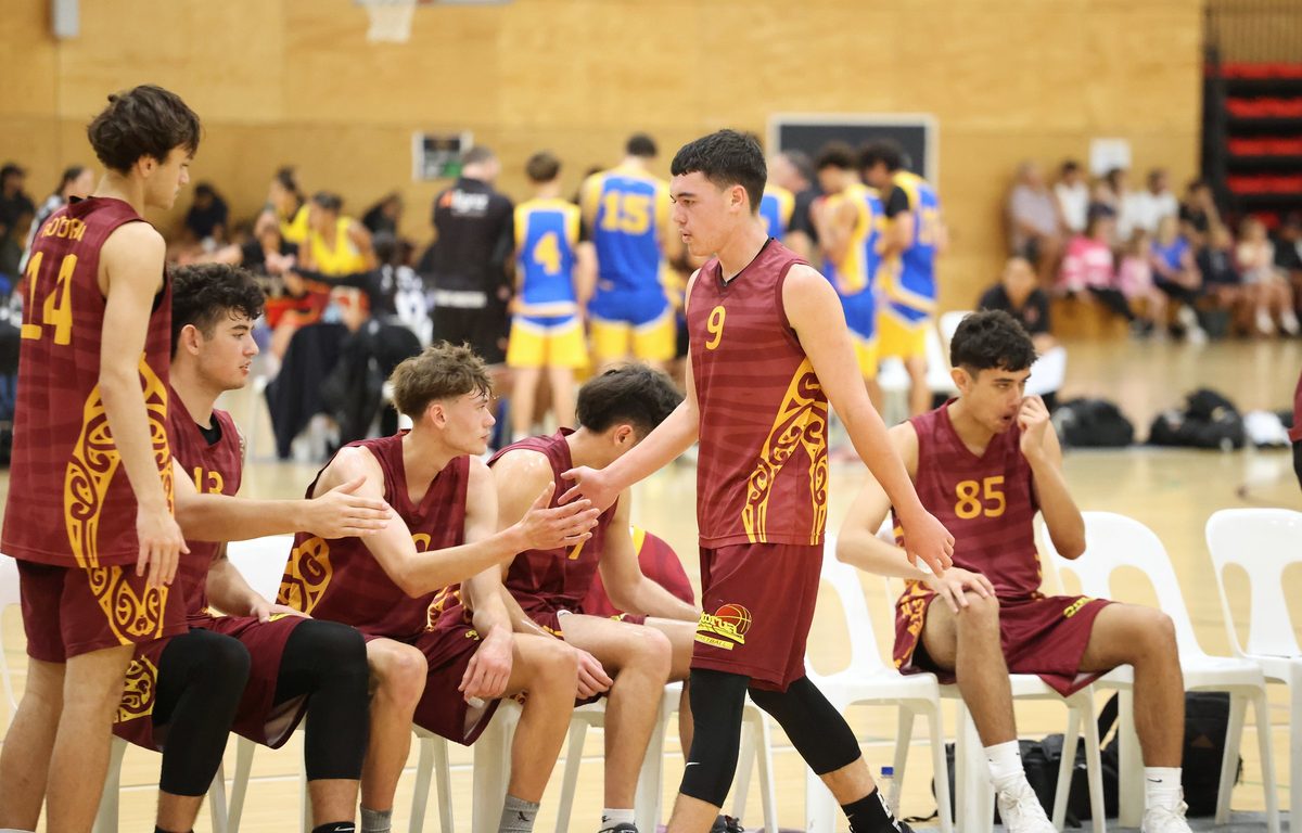Rotorua teammates exchange handshakes at the bench.