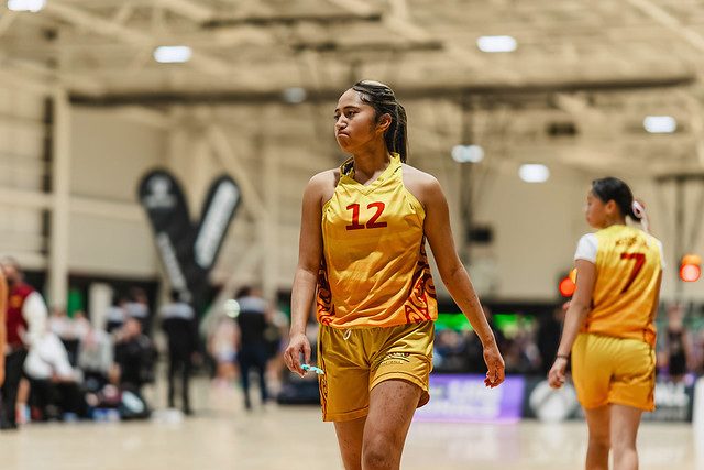 Rotorua number 12 watches the court in a gold uniform.