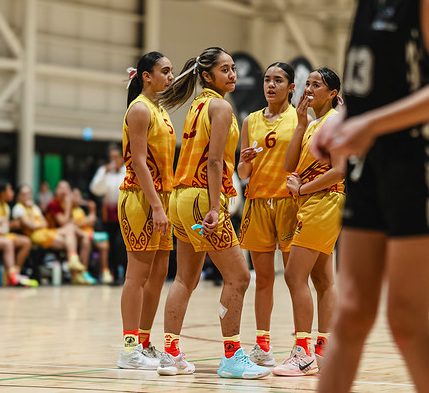 Rotorua players gather briefly on court between plays.