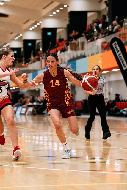 Rotorua number 14 dribbles forward past a defender.