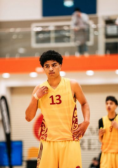 Rotorua number 13 looks across the court in a gold uniform.